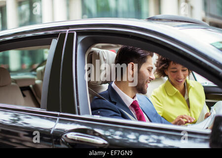 Business people reading paperwork in car Stock Photo