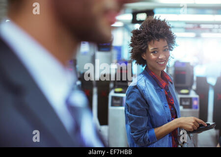 Woman smiling in train station Stock Photo
