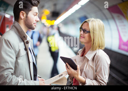Business people talking in subway station Stock Photo