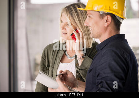 Woman with architect at home Stock Photo