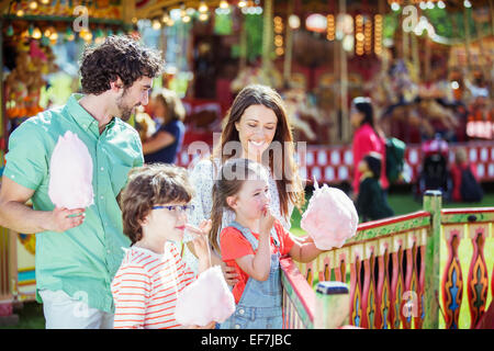 Family with pink candy floss in amusement park Stock Photo
