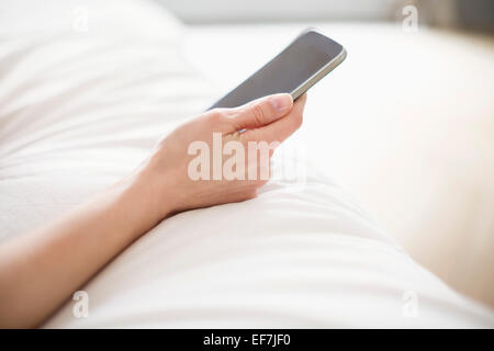 Woman's hand holding a mobile phone