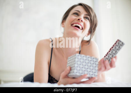 Beautiful happy woman holding a gift box Stock Photo