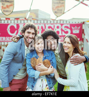 Portrait of four friends having fun in amusement park Stock Photo