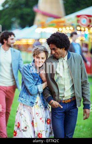 Young multiracial couple smiling in amusement park Stock Photo