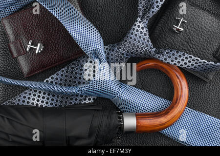 Wallet, tie, cufflinks, umbrella lying on the skin, can be used as background Stock Photo