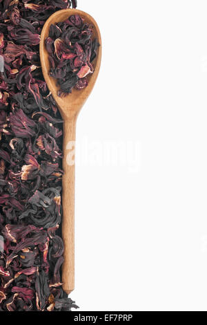 Wooden spoon with dried hibiscus, isolated on white background Stock Photo