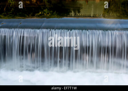 Water pouring over the edge of the old, disused mill pond at Broxbourne ...