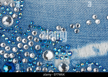 Light-blue denim with blue and silver rhinestones, background Stock Photo