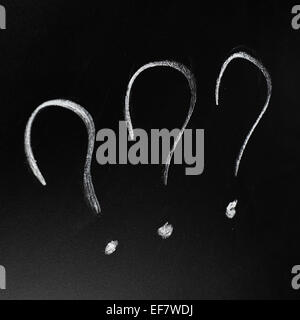 Three question marks on the blackboard Stock Photo