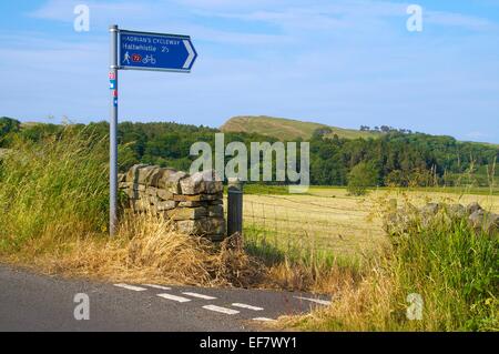 Sign post to Haltwhistle  looking across the B6318 Hadrian's Wall Cycleway sign near Greenhead Cumbria England United Kingdom Stock Photo