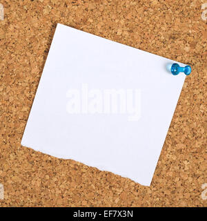 Blank Paper Reminder Note Pinned to a Cork Memory Bulletin Board as Copy Space for Your Message Stock Photo
