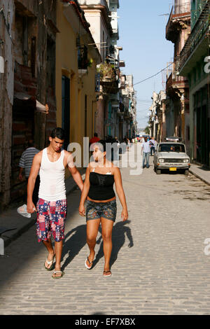 Young Cuban couple walking on the street in Havana, Cuba Stock Photo