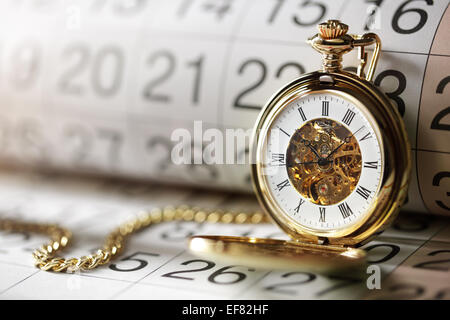 Gold pocket watch and calendar Stock Photo