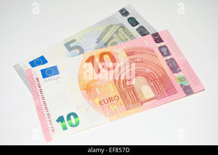 European 5 Euro and 10 Euro currency notes photographed against a white background. Stock Photo