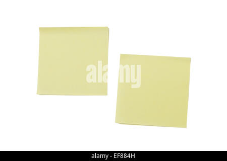 Two blank yellow sticky or adhesive notes, isolated on white background. Stock Photo