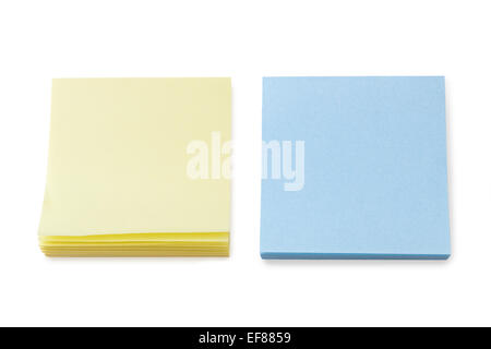 Stacks of blank yellow and blue sticky or adhesive notes, isolated on white background. Stock Photo