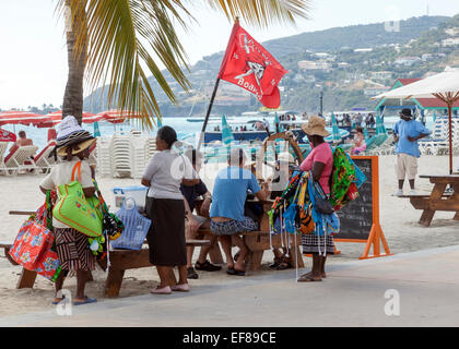 Locals gathering to sell their wares on the beach in Philipsburg on the island of St. Martin in the Caribbean. Stock Photo