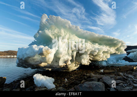 Canada, Nunavut Territory, Melting iceberg stranded by low tide along Frozen Channel at northern edge of Hudson Bay near Arctic Stock Photo