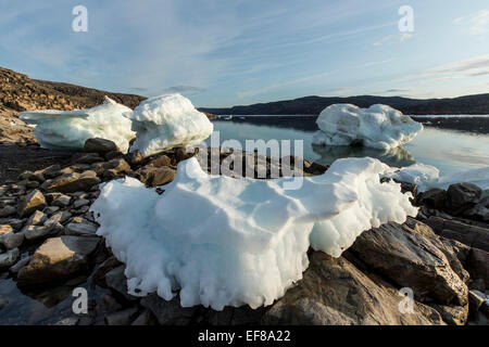 Canada, Nunavut Territory, Melting icebergs stranded by low tide along Frozen Channel at northern edge of Hudson Bay near Arctic Stock Photo