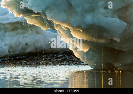 Canada, Nunavut Territory, Water drips from melting iceberg along Frozen Channel at northern edge of Hudson Bay near Arctic Circ Stock Photo