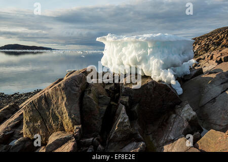 Canada, Nunavut Territory, Melting iceberg stranded by low tide along Frozen Channel at northern edge of Hudson Bay near Arctic Stock Photo