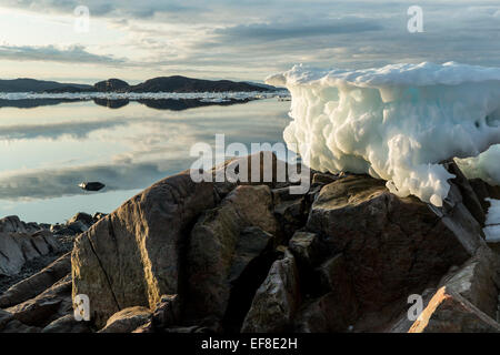 Canada, Nunavut Territory, Melting iceberg stranded by low tide along Frozen Channel at northern edge of Hudson Bay near Arctic Stock Photo