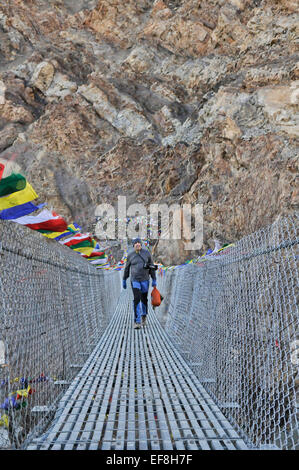 Trekker in a hanging in the Mustang area of Nepal Stock Photo