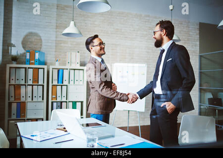 Successful businessmen handshaking after negotiation Stock Photo