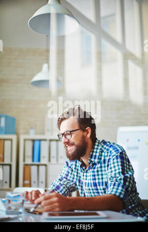 Happy young businessman using modern technologies Stock Photo