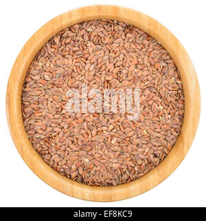 Brown flax seeds in wooden bowl isolated on white background. Flax seeds are rich in omega-3 fatty acid. Top view. Stock Photo