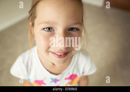 Portrait of smiling girl (6-7) looking up at camera Stock Photo