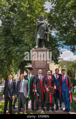 Arab students, Medical University graduates, at statue of Polish poet Adam Mickiewicz, in Ivano-Frankivsk, Ukraine Stock Photo