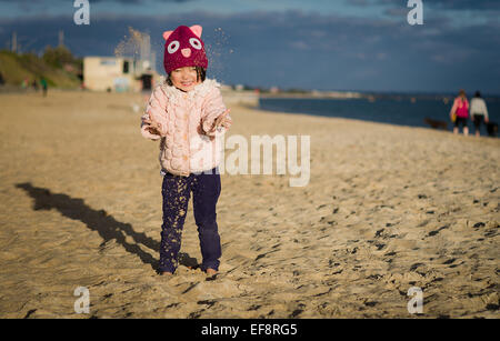 Australia, Melbourne, Young girl playing on sandy beach