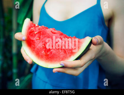 Woman holding slice of watermelon Stock Photo