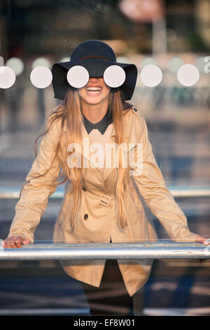 Smiling girl (12-13 )in hat seeing through bus stop