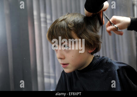 10 year old schoolboy having a haircut Stock Photo