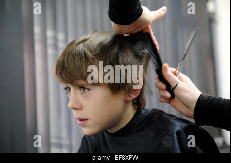 10 year old schoolboy having a haircut Stock Photo