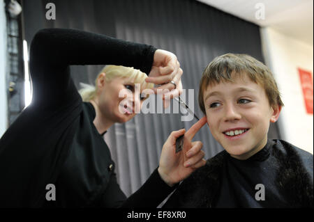 10 year old schoolboy having a haircut Stock Photo