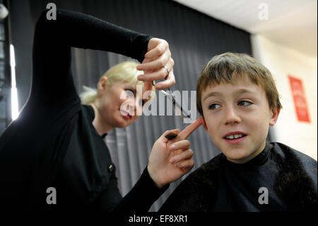 10 year old schoolboy having a haircut Stock Photo