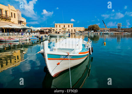 Brightly-painted traditional style boat moored in the old boat harbour at Rethymno, Crete Stock Photo