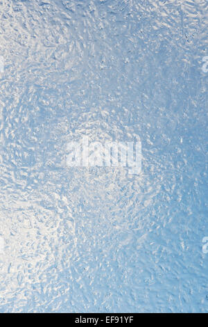 Textured Ice pattern against blue cloudy sky Stock Photo