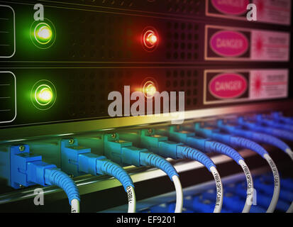 Close up of network infrastructure in data center. Blur effect with focus on patchcords at the foreground. Stock Photo