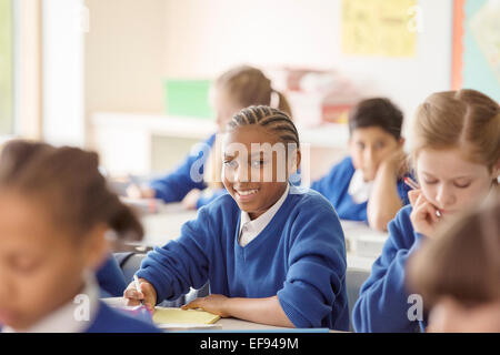 Portrait of schoolboy learning in classroom Stock Photo