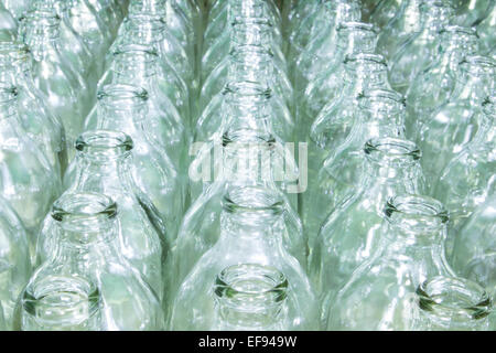Clear glass bottle filled with water placed at different vertical opening. Stock Photo