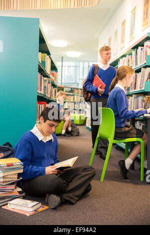 Teenage students learning in college library Stock Photo