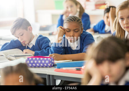 Elementary school children asleep and bored in classroom Stock Photo