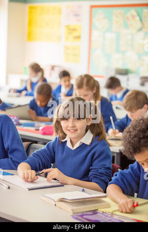 Elementary school children in classroom during lesson Stock Photo