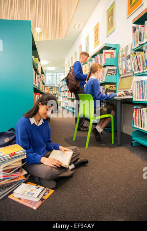 Students using computer and learning in library Stock Photo