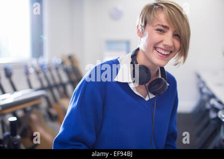 Portrait of female student with headphones in classroom Stock Photo